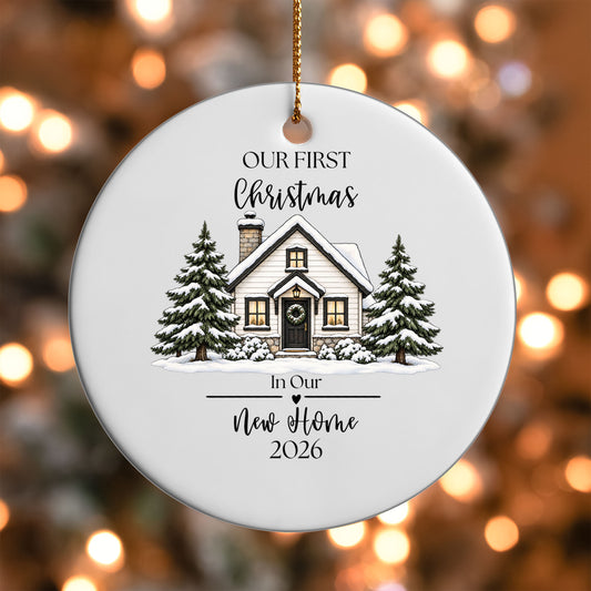 Our First Christmas New Home ornament UV DTF transfer on a round white ornament with a bokeh light background