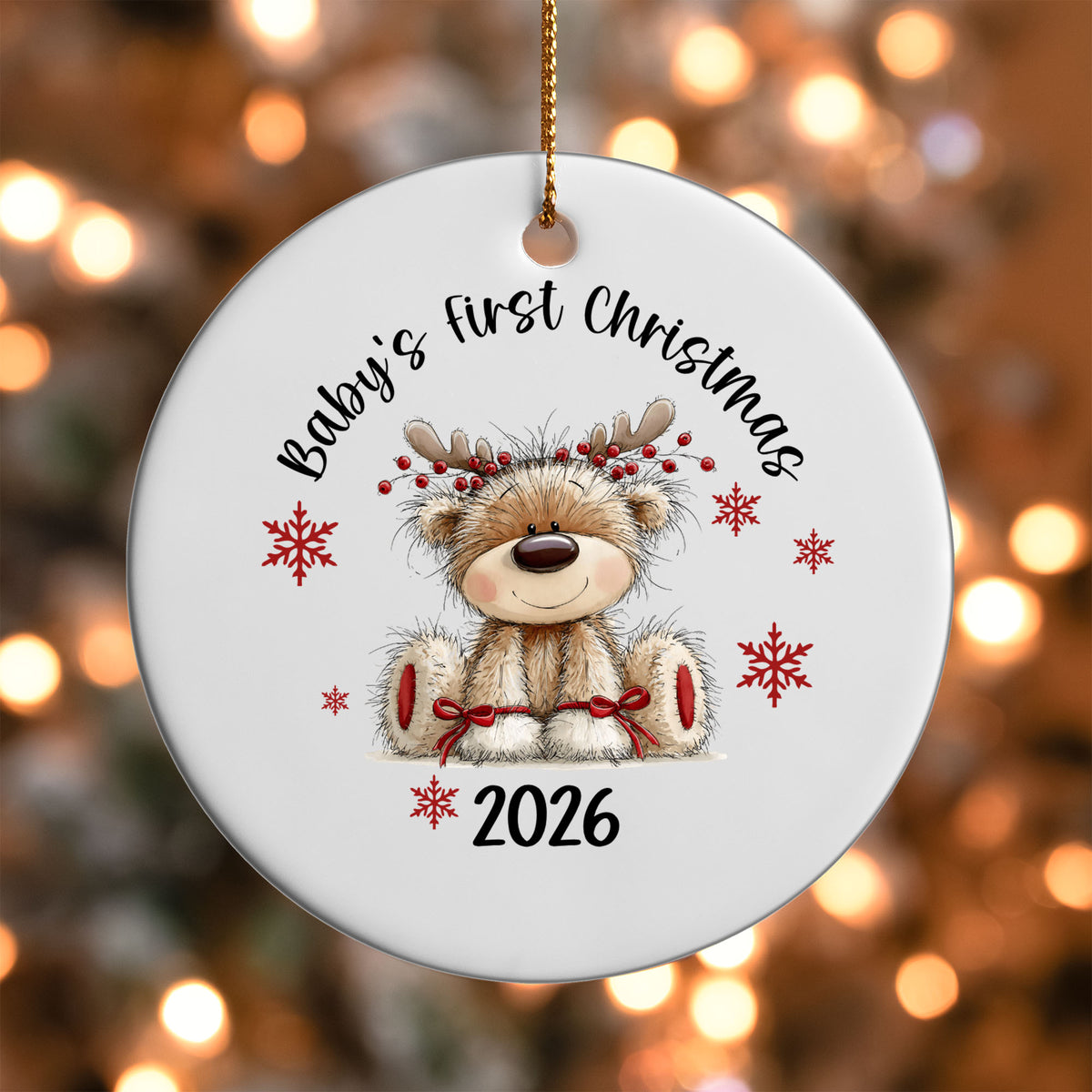 Baby's First Christmas ornament UV DTF transfer on a round white ornament with a bokeh light background