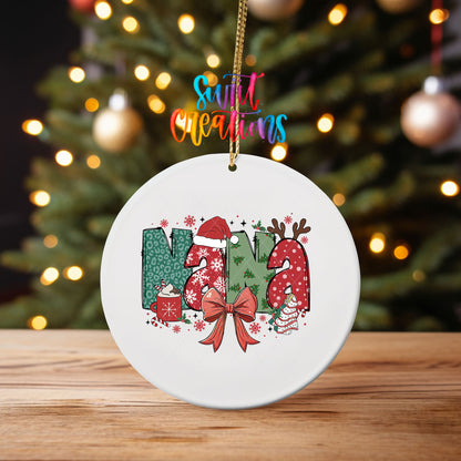 Nana ornament UV DTF transfer on an ornament on a wooden table with tree lights behind it