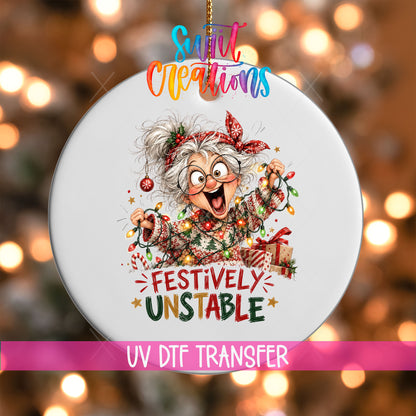 Festively Unstable UV DTF transfer on a white ornament with a pink UV DTF Transfer banner and bokeh lights