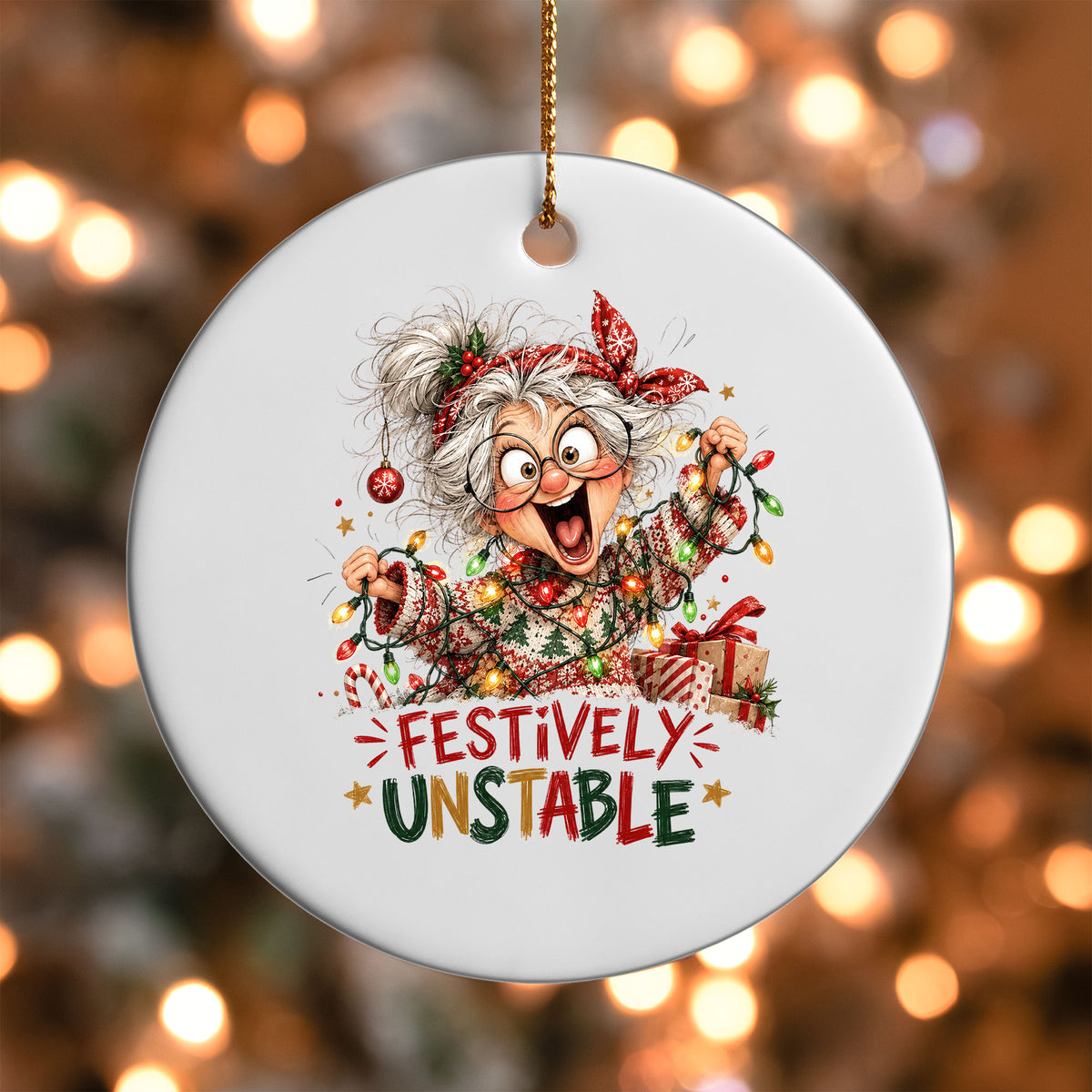 Festively Unstable ornament UV DTF transfer on a round white ornament with a bokeh light background