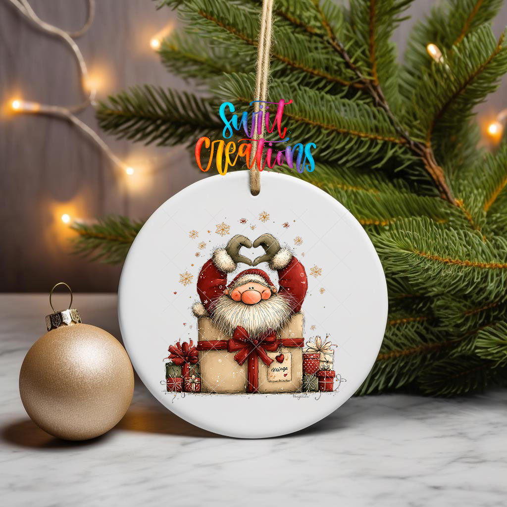 Cute Santa in a gift box ornament UV DTF transfer on a hanging ornament with pine branches and a gold bauble