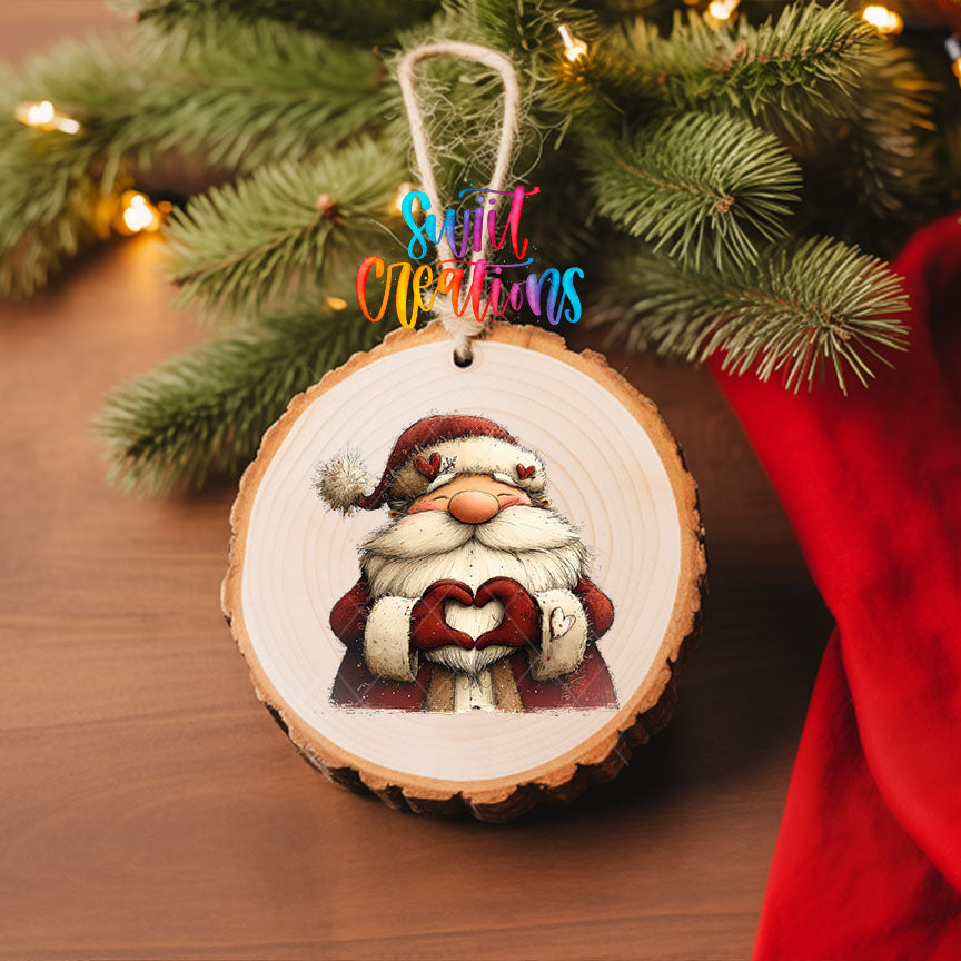 Cute Santa making heart hands UV DTF transfer on a wood slice ornament with pine branches and a red stocking