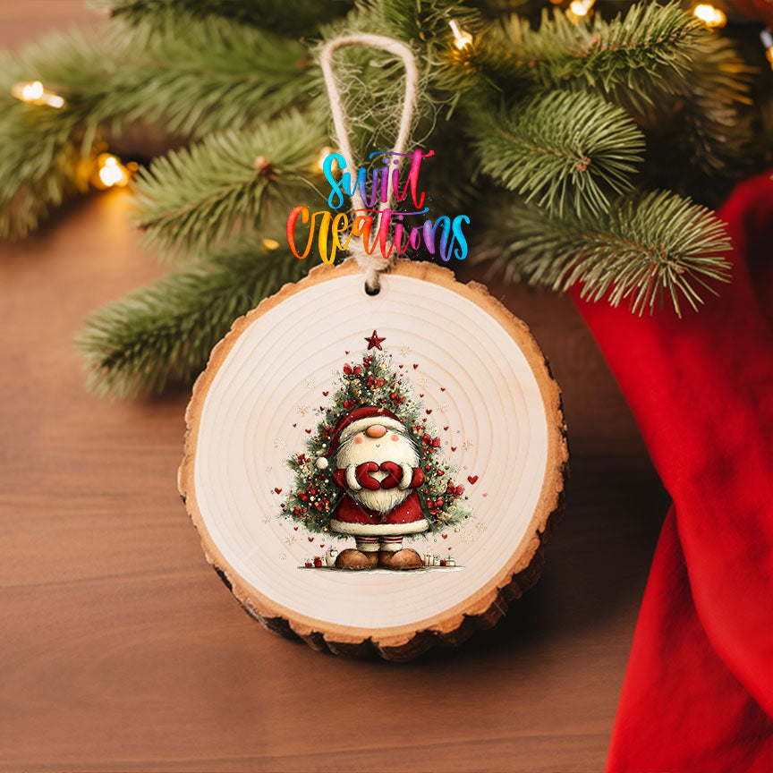 Cute Santa with heart hands in front of a Christmas tree UV DTF transfer on a wood slice ornament with pine branches and a red stocking