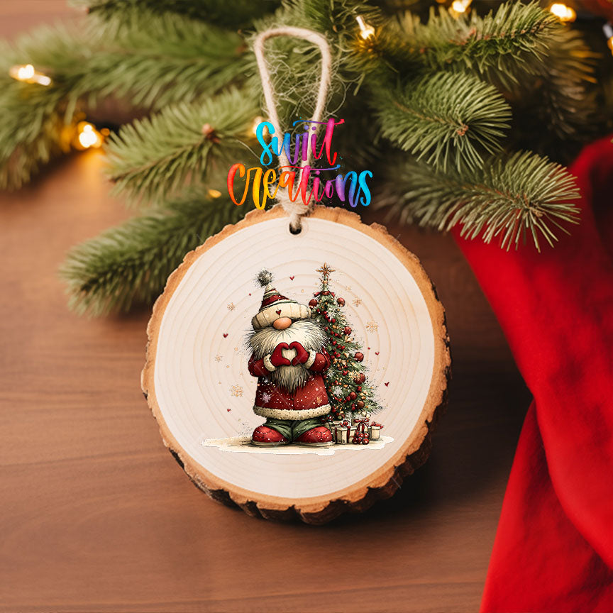 Cute Santa in a knit hat beside a Christmas tree UV DTF transfer on a wood slice ornament with pine branches and a red stocking