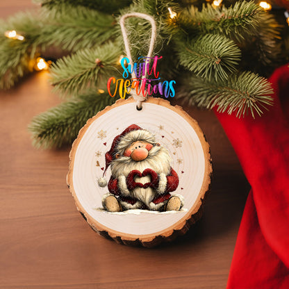 Cute sitting Santa making heart hands UV DTF transfer on a wood slice ornament with pine branches and a red stocking