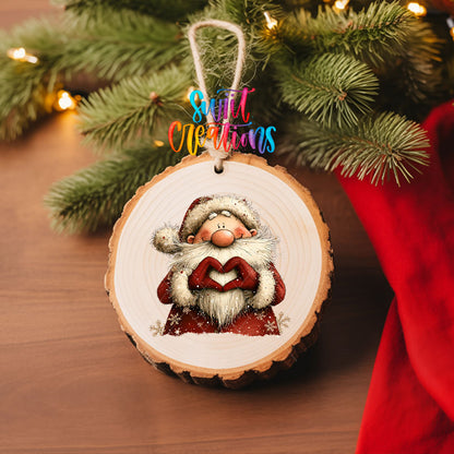 Cute Santa in a snowflake coat making heart hands UV DTF transfer on a wood slice ornament with pine branches and a red stocking