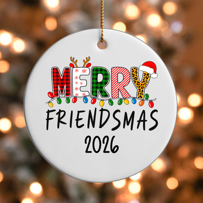 Merry Friendsmas 2026 ornament UV DTF transfer on a round white ornament with a bokeh light background