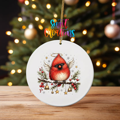Angel cardinal with halo and wings UV DTF transfer on an ornament on a wooden table with tree lights