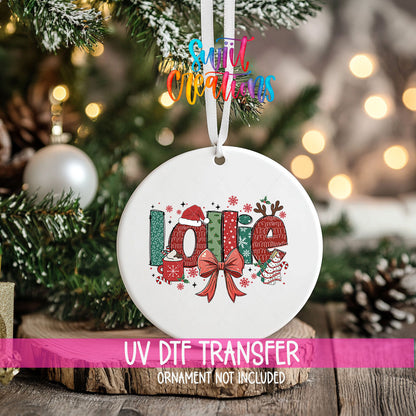 Lollie grandma name UV DTF transfer on a hanging ornament above a wood slice with pinecones and a UV DTF Transfer banner