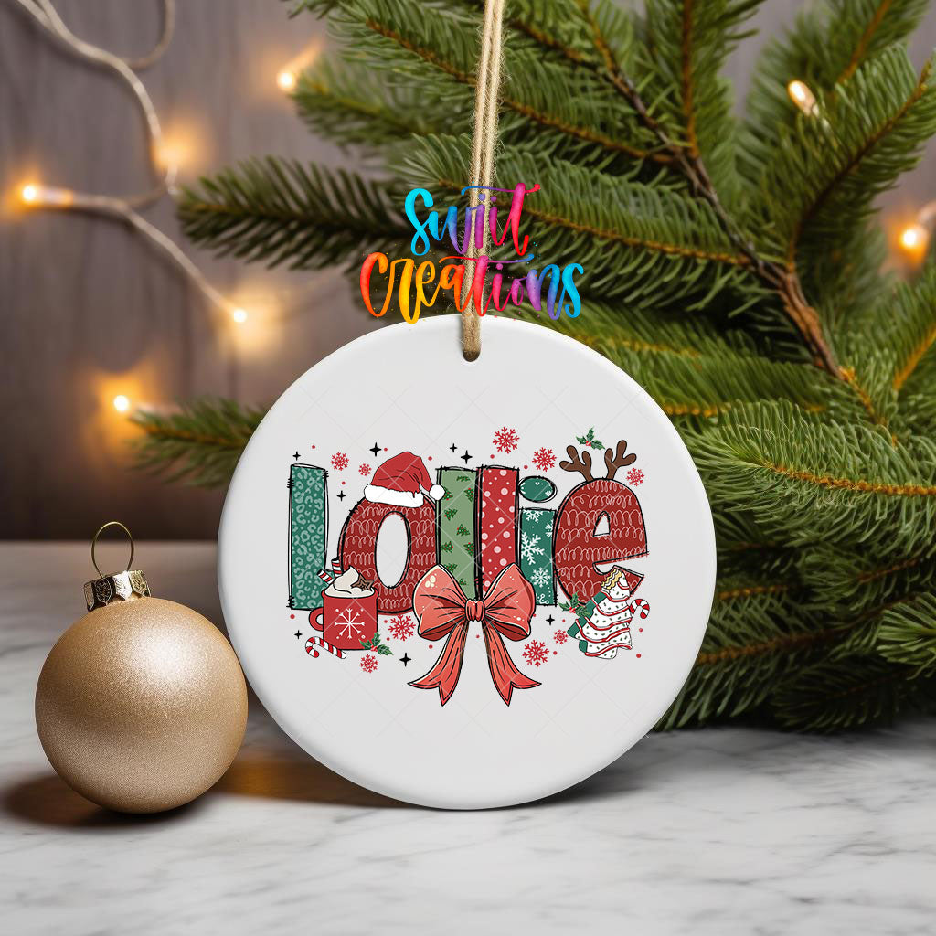 Lollie grandma name UV DTF transfer on an ornament hanging from pine branches beside a gold bauble