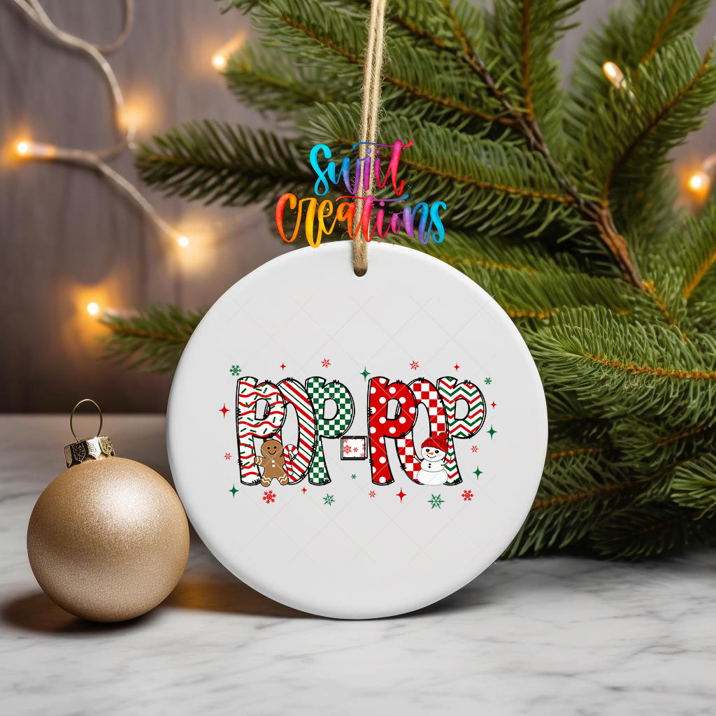 Pop-Pop grandpa name UV DTF transfer on an ornament hanging from pine branches beside a gold bauble