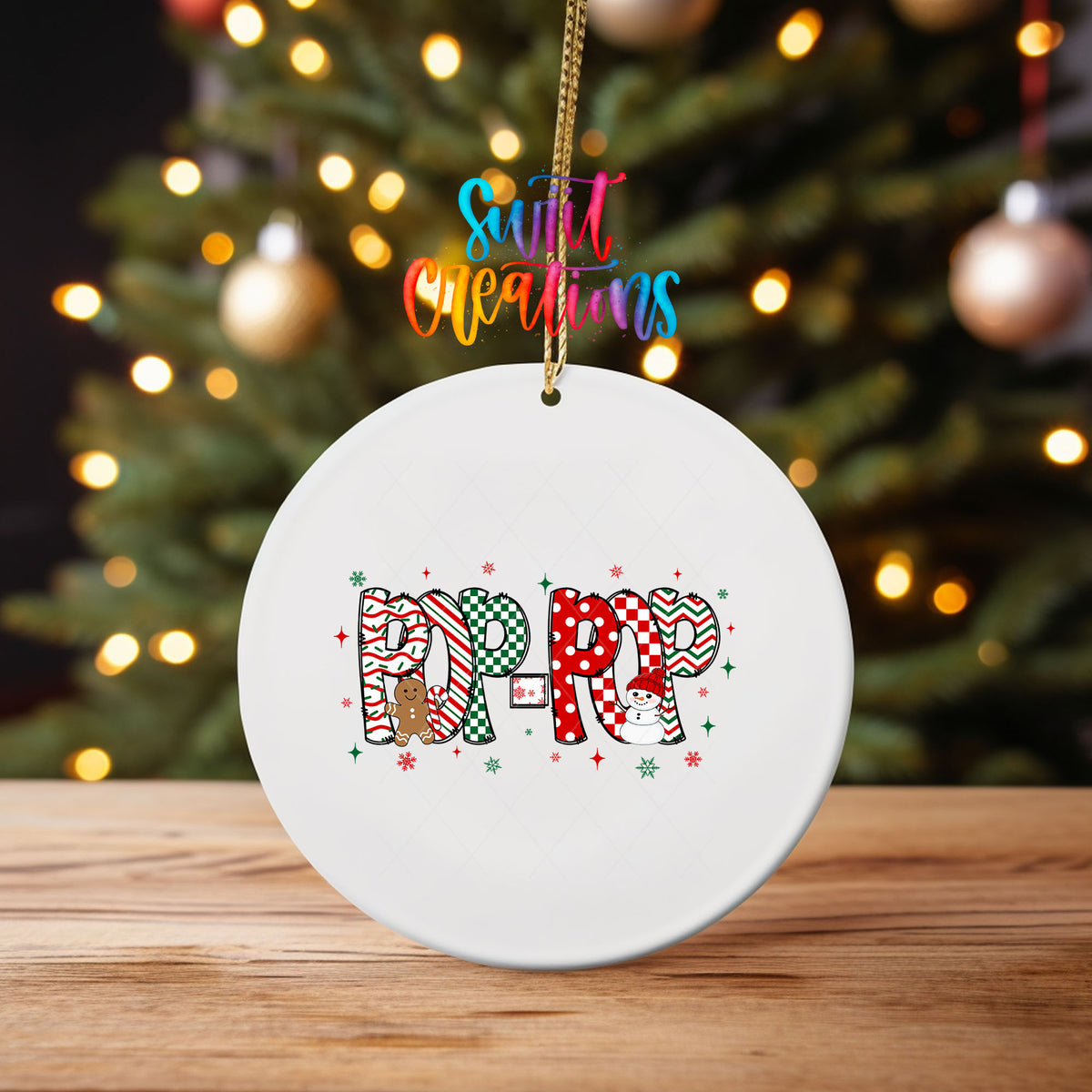 Pop-Pop grandpa name UV DTF transfer on an ornament on a wooden table with Christmas tree lights
