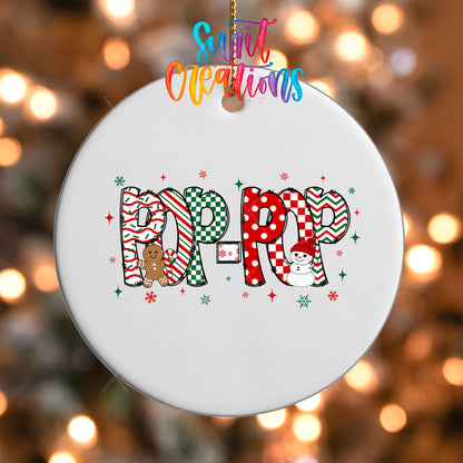 Close-up of the Pop-Pop grandpa name UV DTF transfer with a gingerbread man and snowman on a white ornament