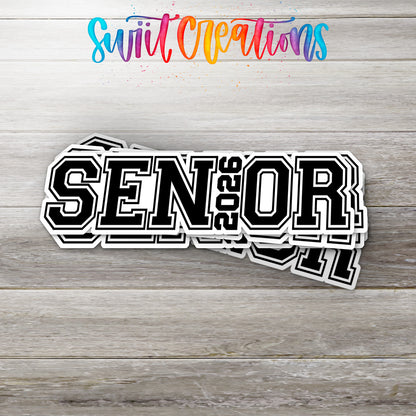 Stack of Senior 2026 glossy stickers on a gray wood table