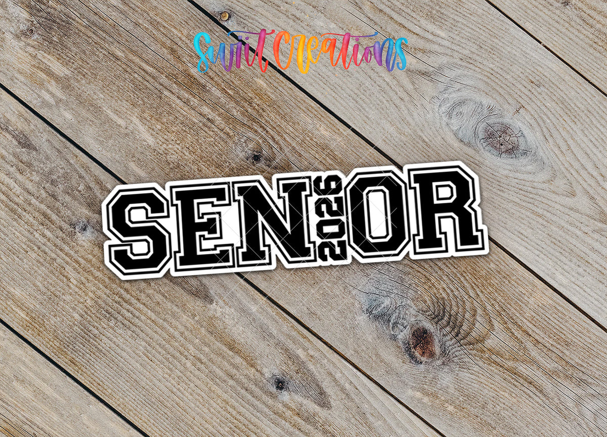 Close-up of the Senior 2026 sticker with 2026 inside the word SENIOR on rustic wood
