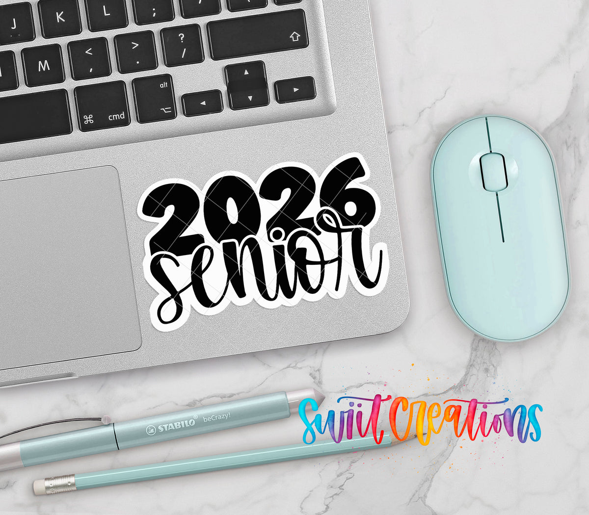 2026 Senior vinyl sticker on a silver laptop next to a mint mouse and pens