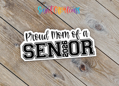 Close-up of the Proud Mom of a 2026 Senior sticker with 2026 inside the word SENIOR on rustic wood