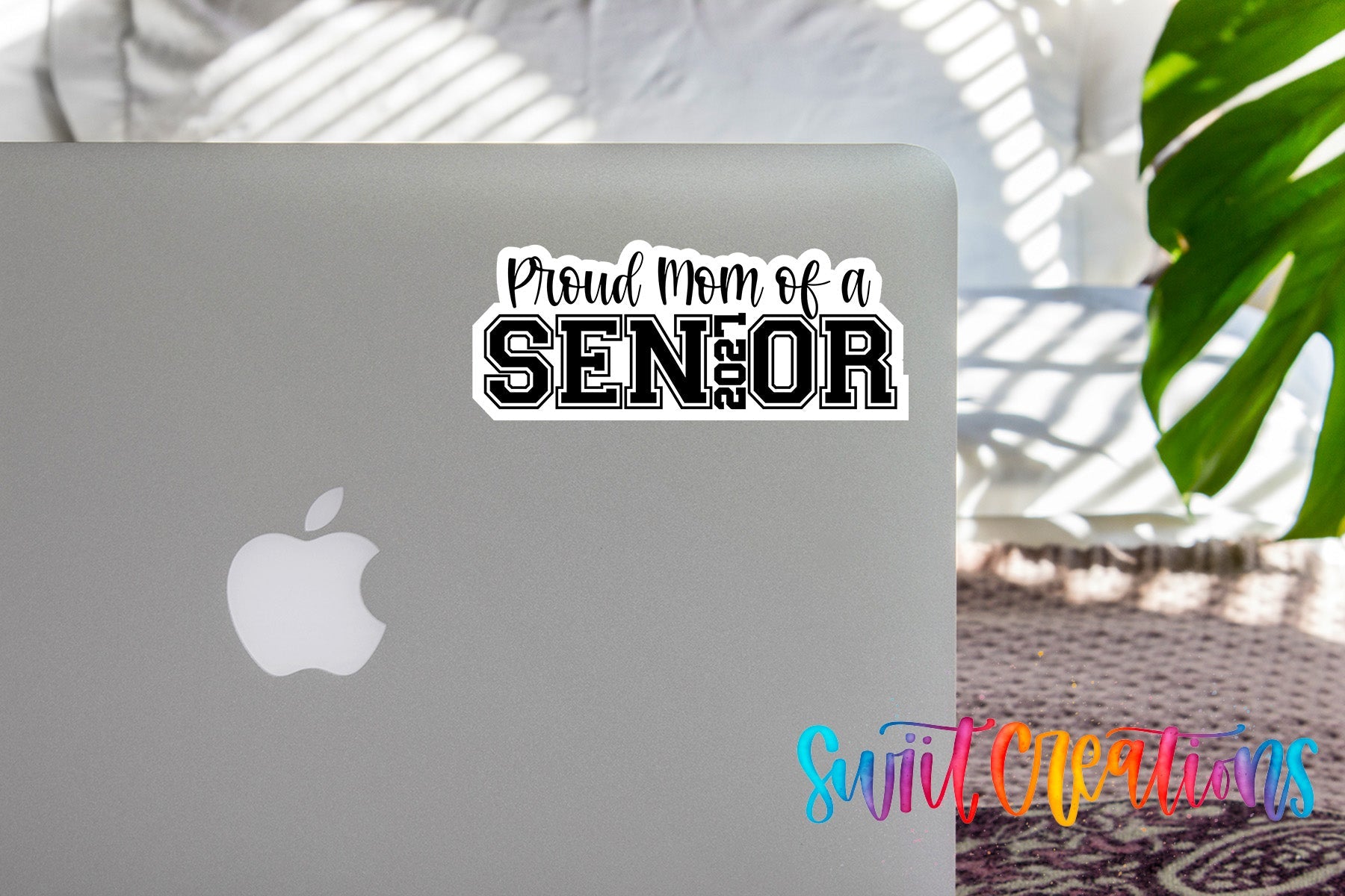 Proud Mom of a 2027 Senior waterproof vinyl sticker displayed on a MacBook