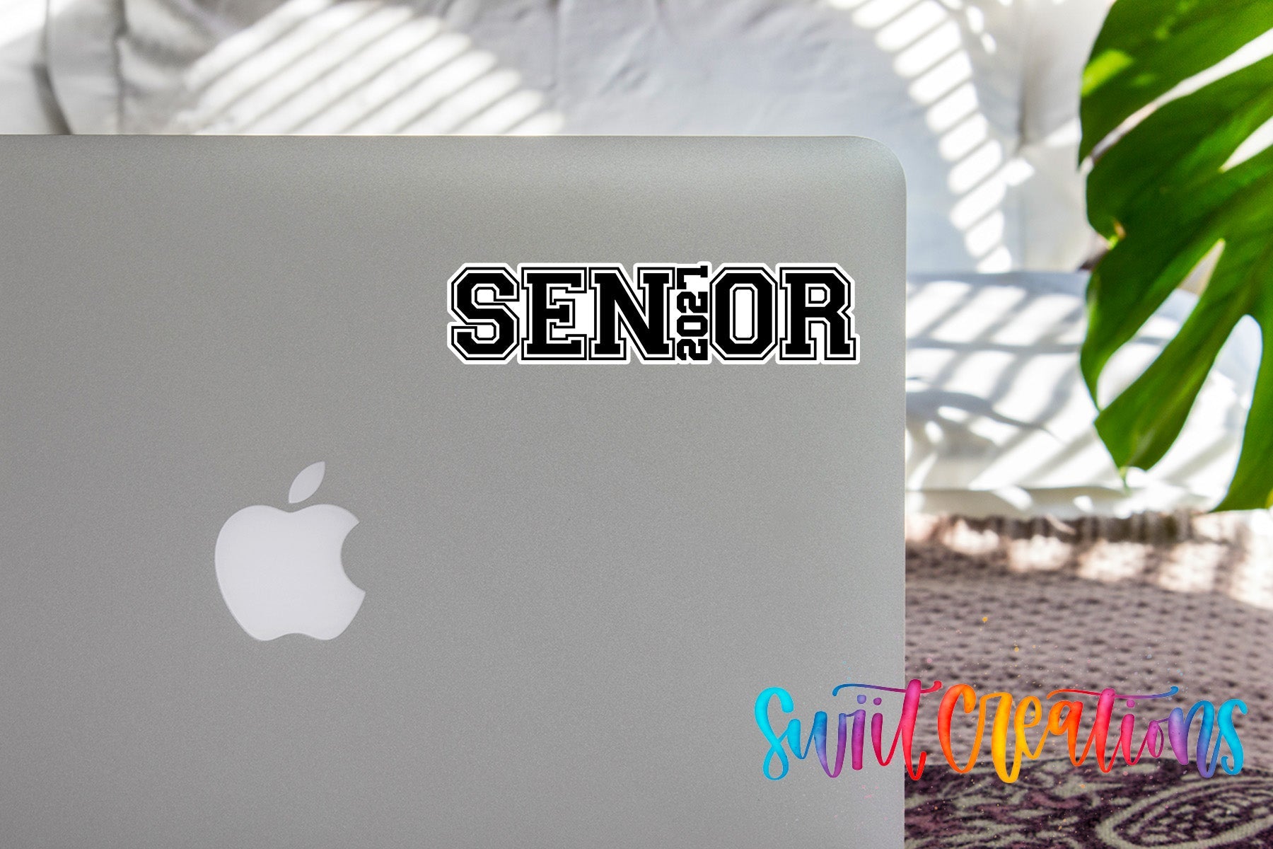 Senior 2027 waterproof vinyl sticker displayed on a MacBook