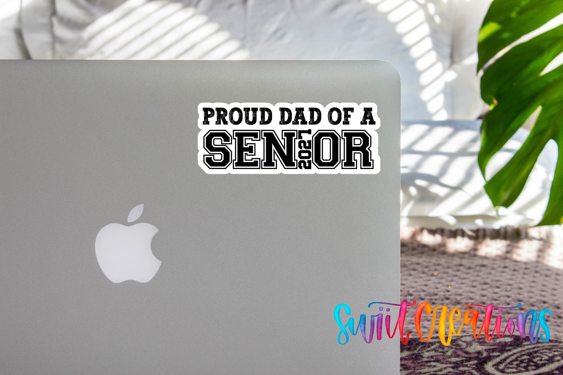 Proud Dad of a Senior 2027 waterproof vinyl sticker displayed on a MacBook