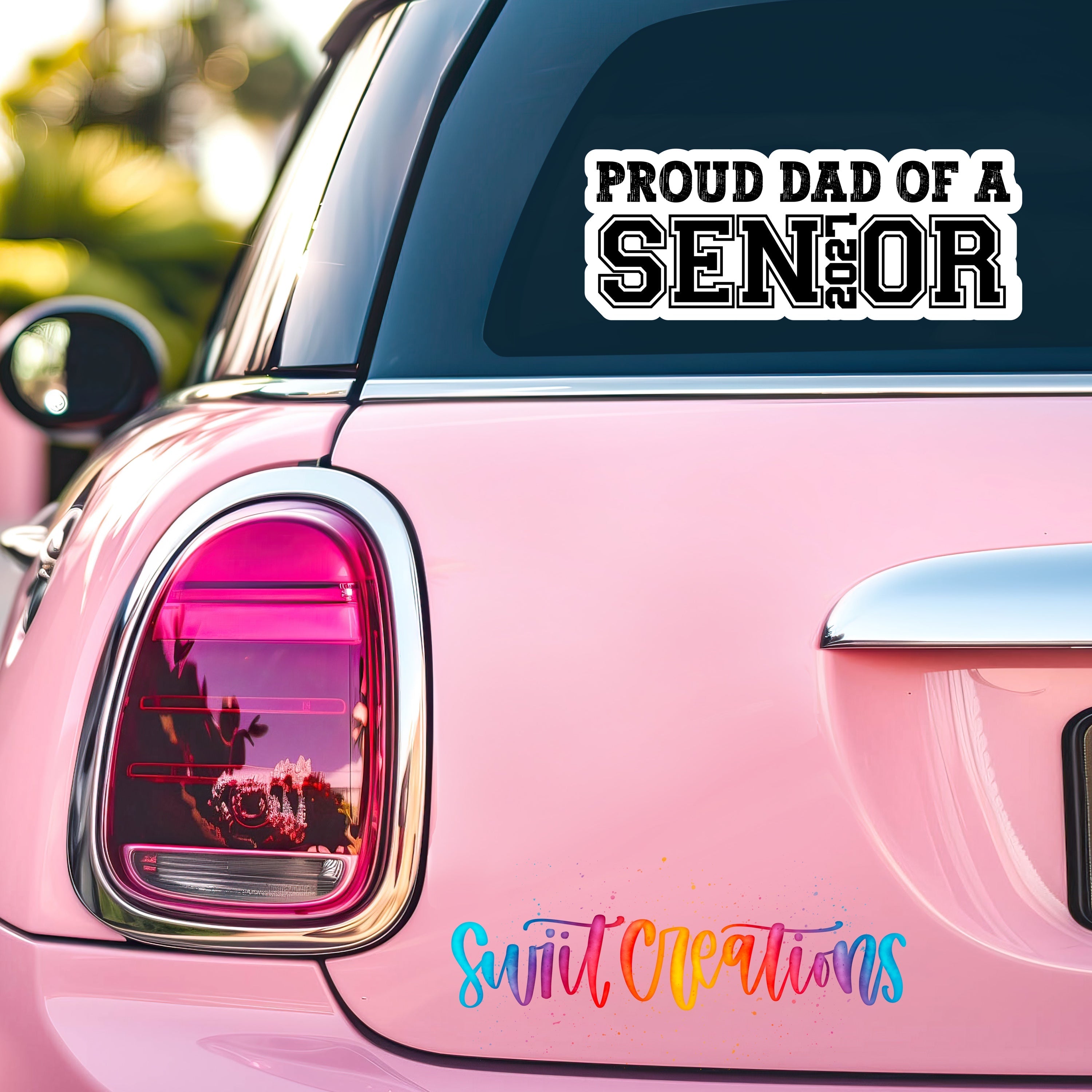 Proud Dad of a Senior 2027 waterproof vinyl sticker displayed on a car window