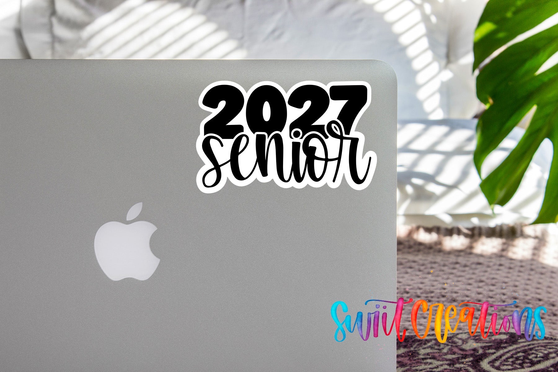 2027 Senior waterproof vinyl sticker displayed on a MacBook