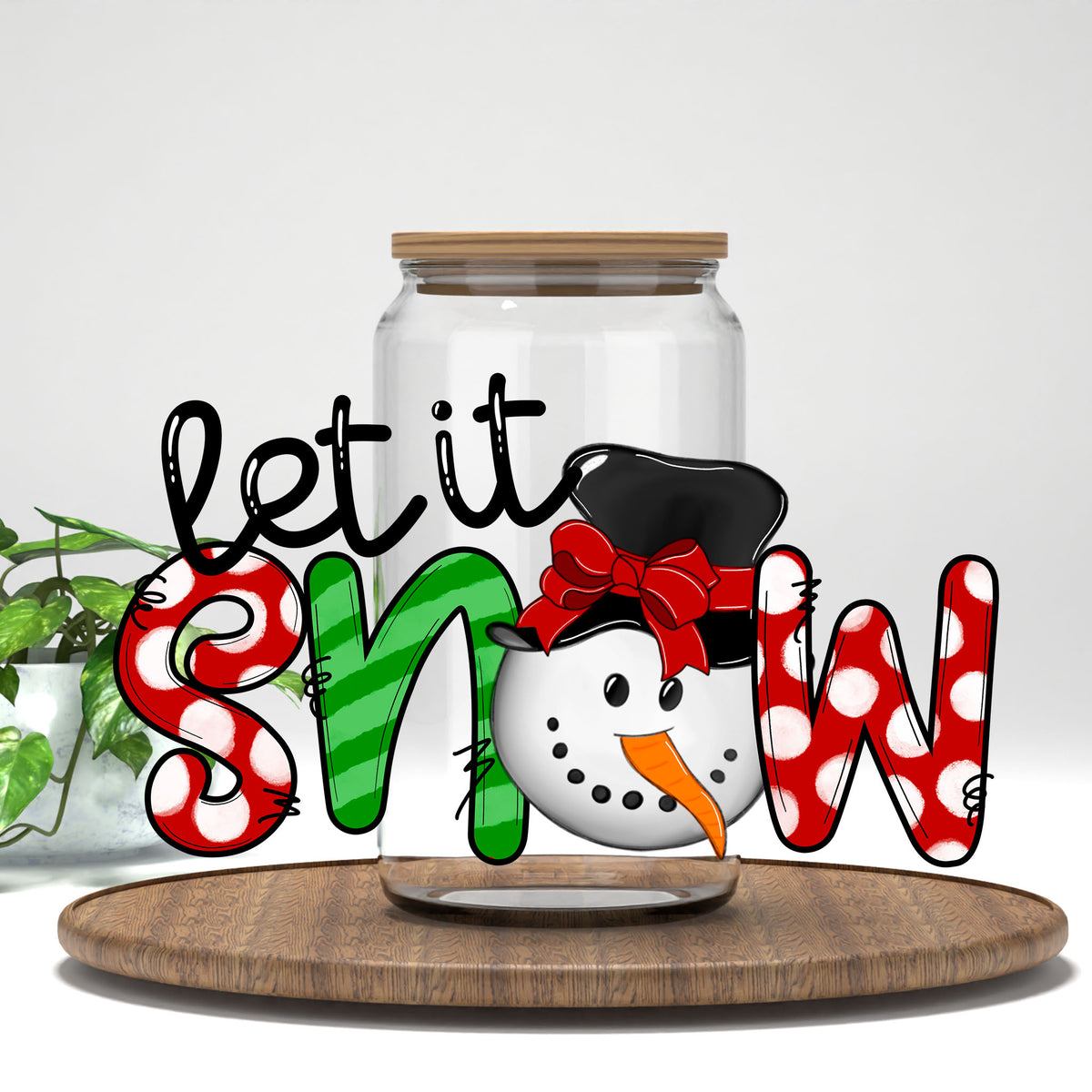 Let It Snow polka dot letters and snowman UV DTF transfer on a clear glass can