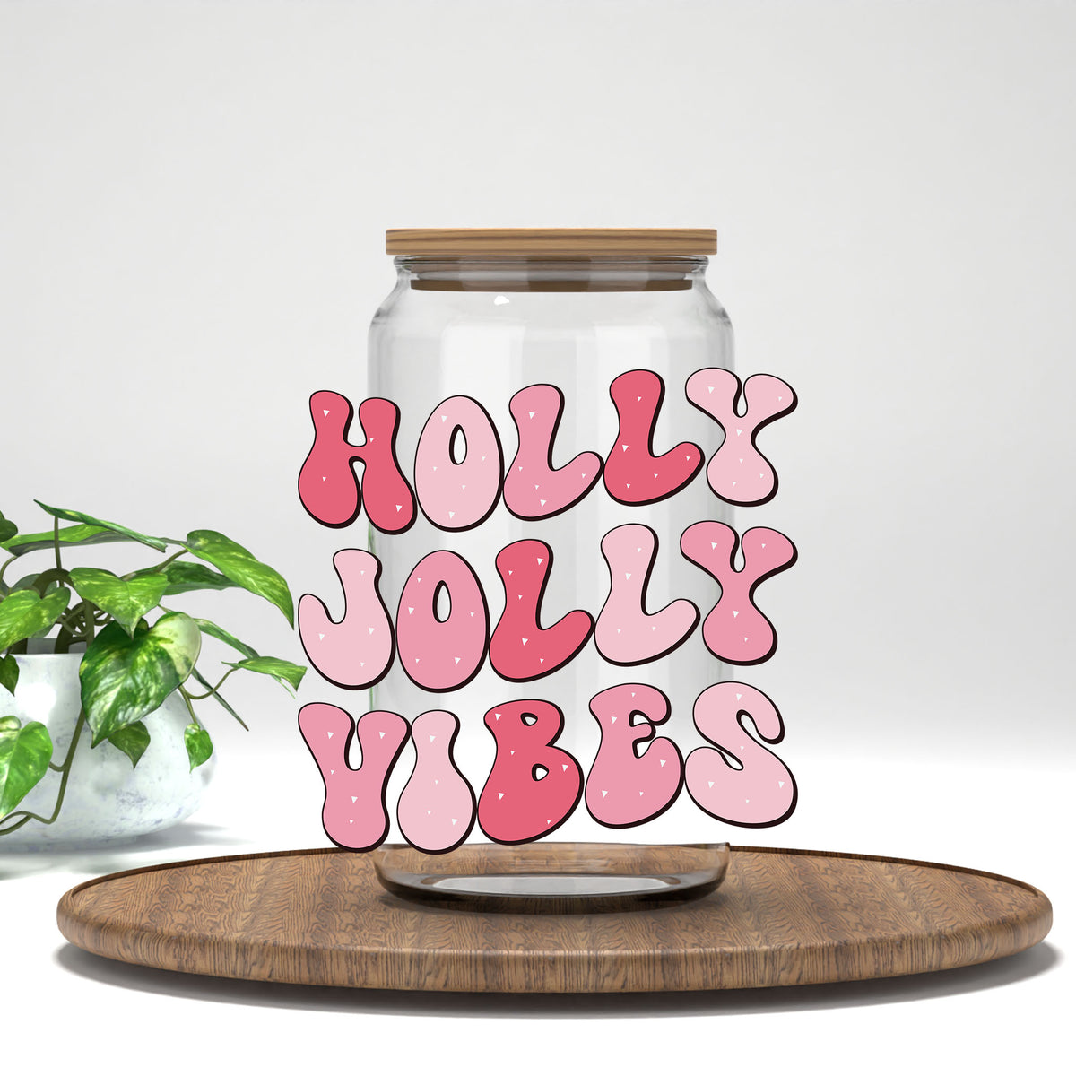 Holly Jolly Vibes UV DTF transfer on a clear glass can