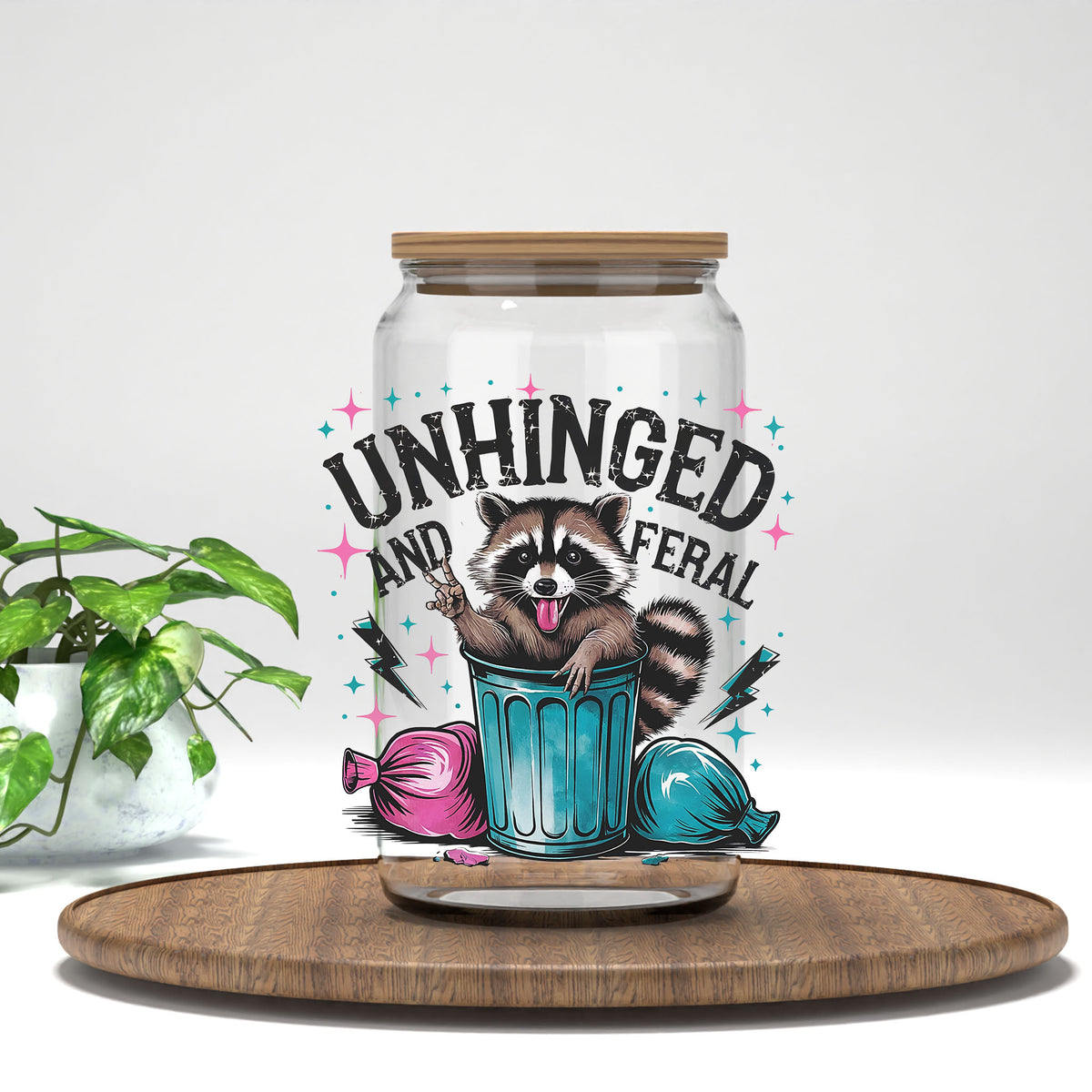 Unhinged and Feral UV DTF transfer on a clear glass can
