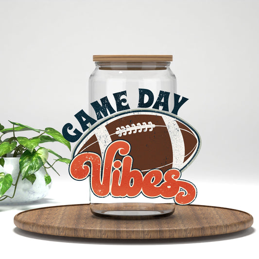 Game Day Vibes football UV DTF transfer on a clear glass can