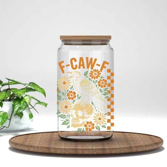 F-CAW-F raven, skull, and orange flowers UV DTF transfer on a clear glass can