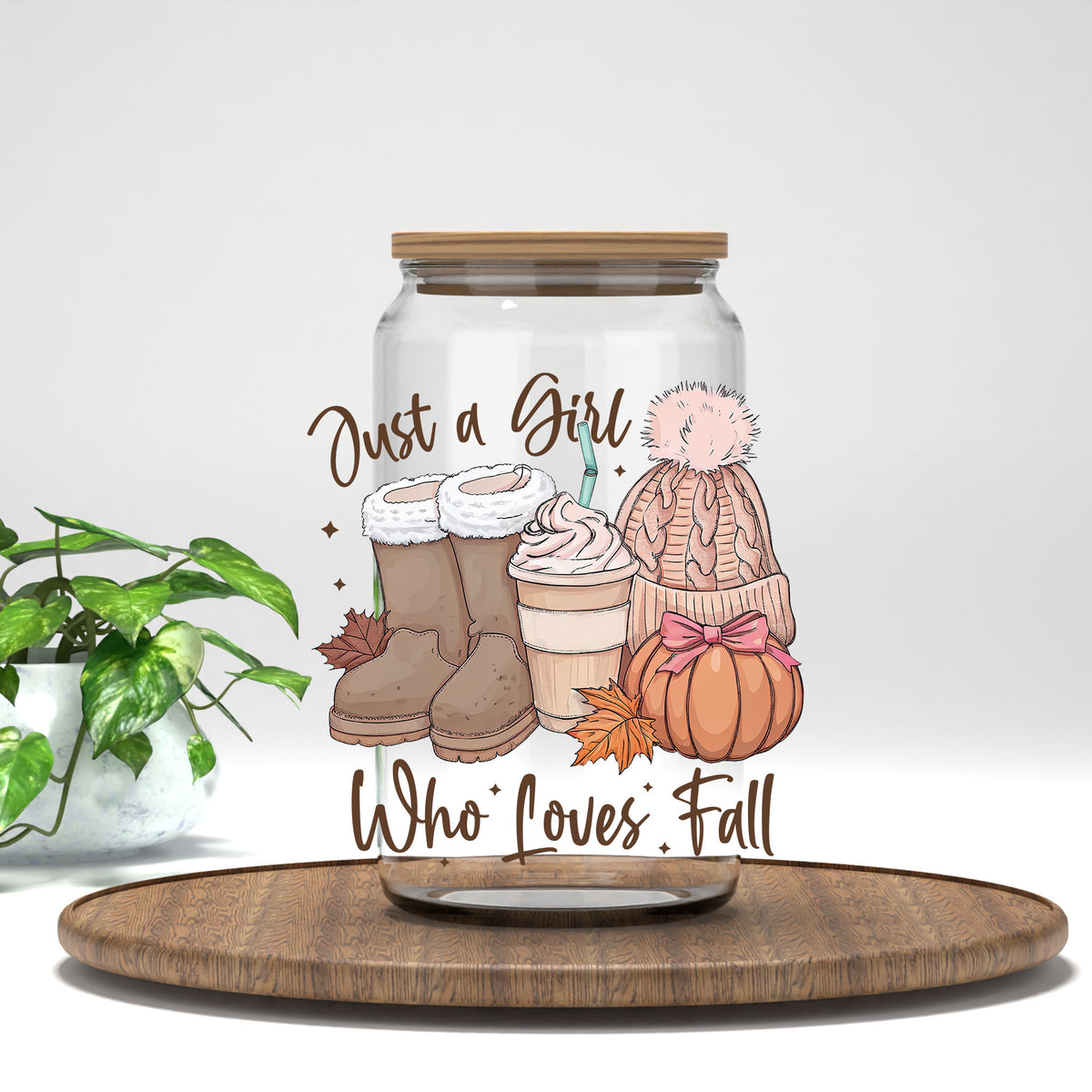 Just a Girl Who Loves Fall boots, latte, and pink beanie UV DTF transfer on a clear glass can