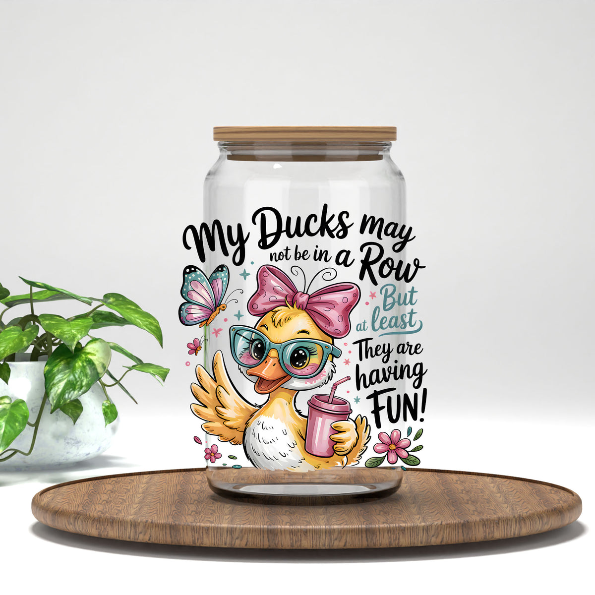 My Ducks May Not Be in a Row duck with a pink drink UV DTF transfer on a clear glass can