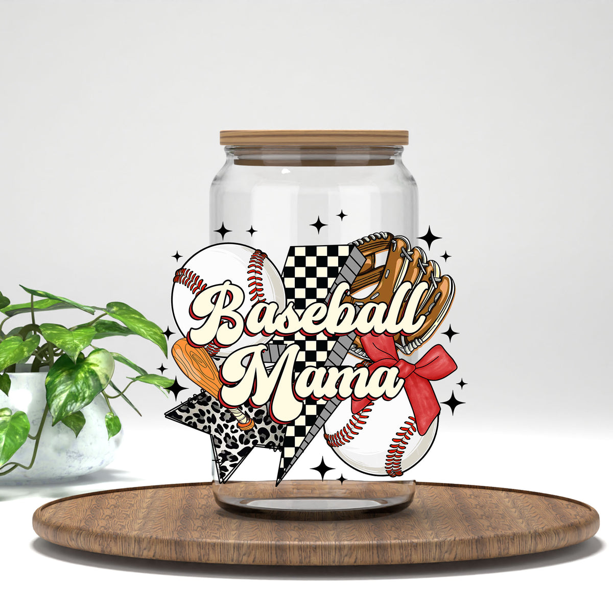 Baseball Mama glove, bow, and leopard bolt UV DTF transfer on a clear glass can