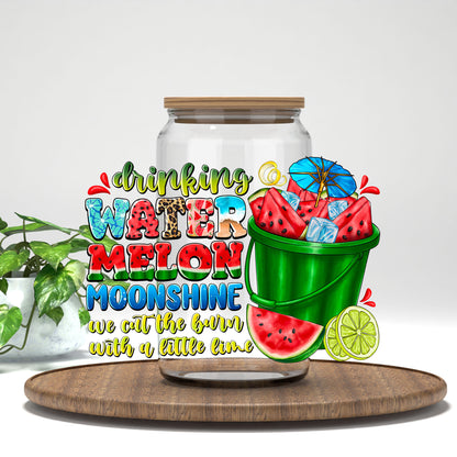 Drinking Watermelon Moonshine UV DTF transfer on a clear glass can