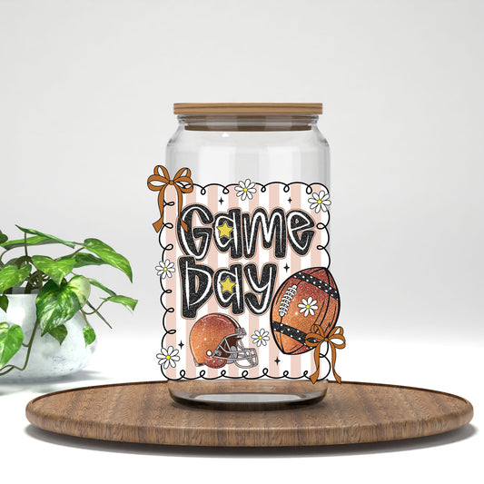 Game Day football and bows UV DTF transfer on a clear glass can