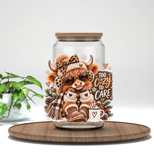 Too Cozy To Care highland cow UV DTF transfer on a clear glass can with a bamboo lid