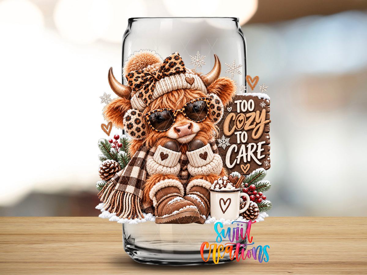 Close-up of the Too Cozy To Care highland cow UV DTF transfer on a clear glass can