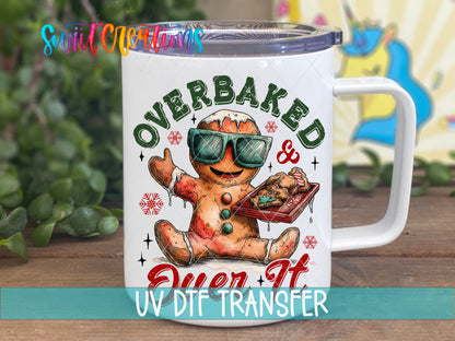 Overbaked And Over It gingerbread UV DTF transfer on a white stainless steel mug with a lid