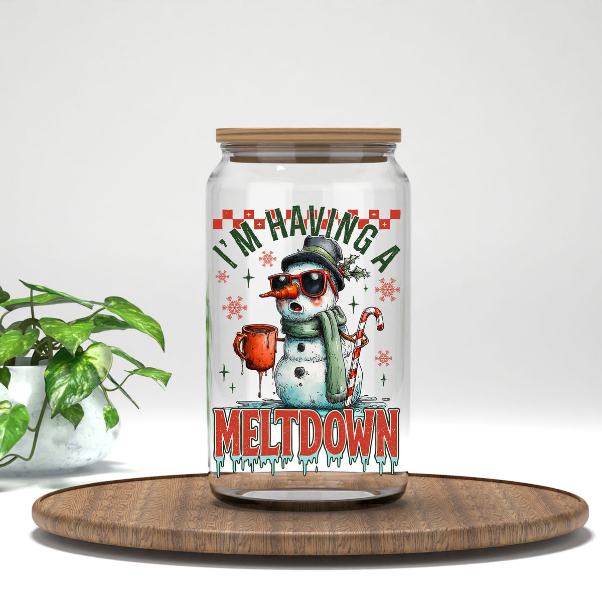 I'm Having A Meltdown snowman UV DTF transfer on a clear glass can with a bamboo lid