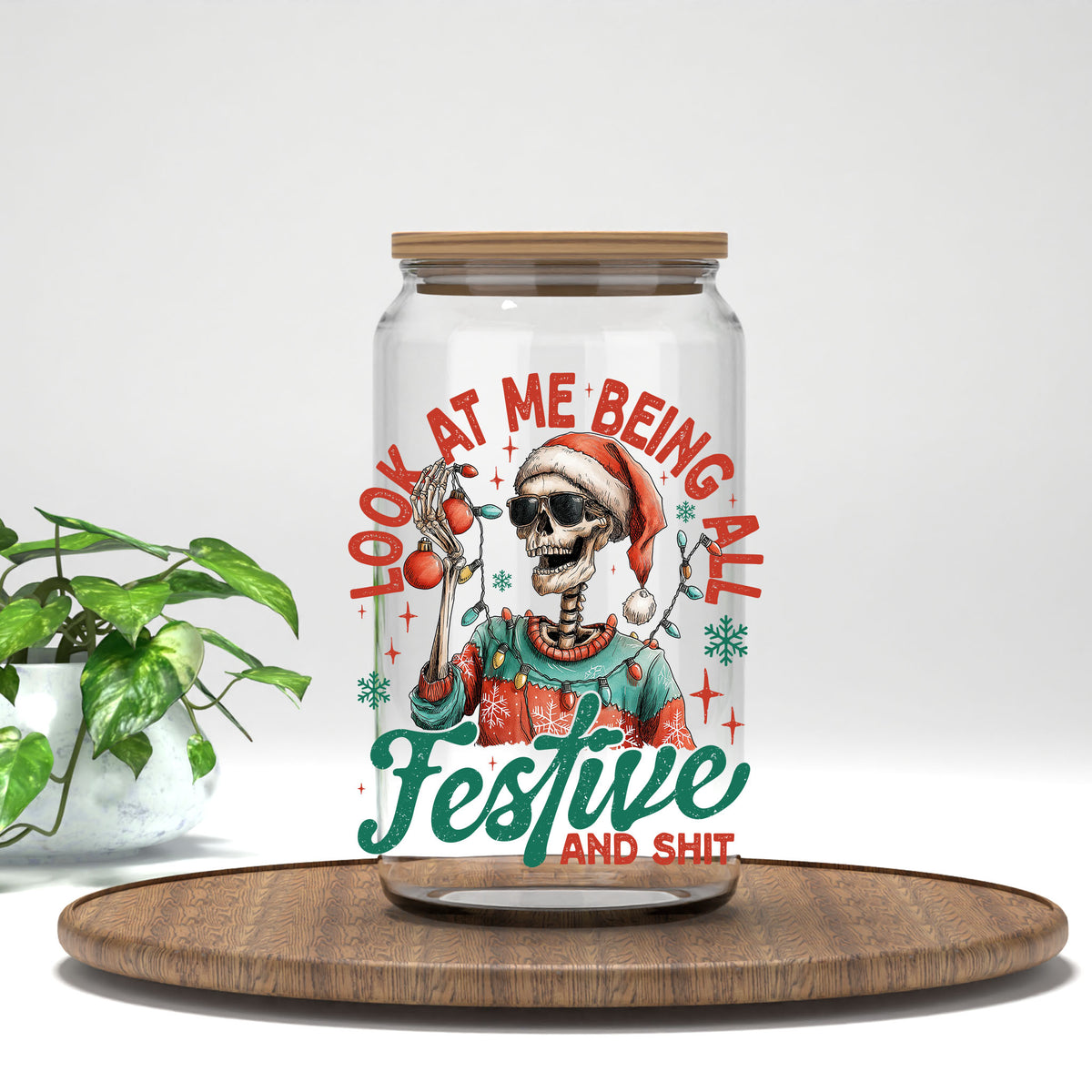 Look At Me Being All Festive And Sh*t skeleton UV DTF transfer on a clear glass can with a bamboo lid