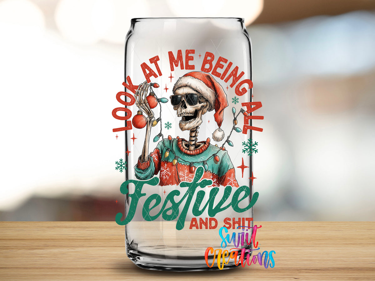 Close-up of the Look At Me Being All Festive And Sh*t skeleton UV DTF transfer on a clear glass can