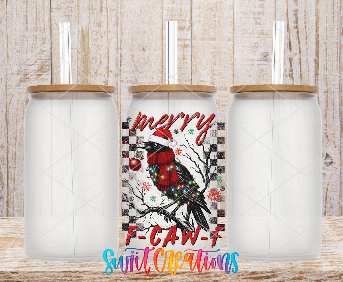 Merry F-CAW-F crow UV DTF transfer on three frosted glass cans on a wood background