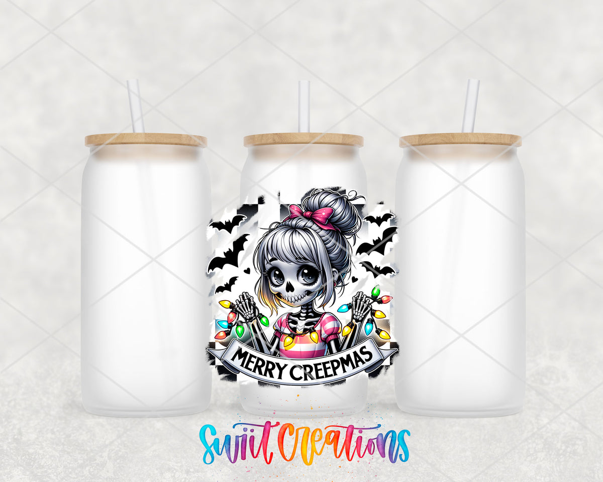 Merry Creepmas skeleton girl UV DTF transfer on three frosted glass cans on a white background