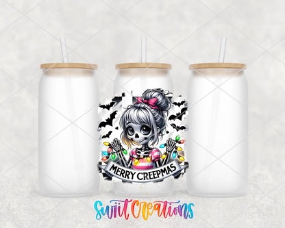 Merry Creepmas skeleton girl UV DTF transfer on three frosted glass cans on a white background