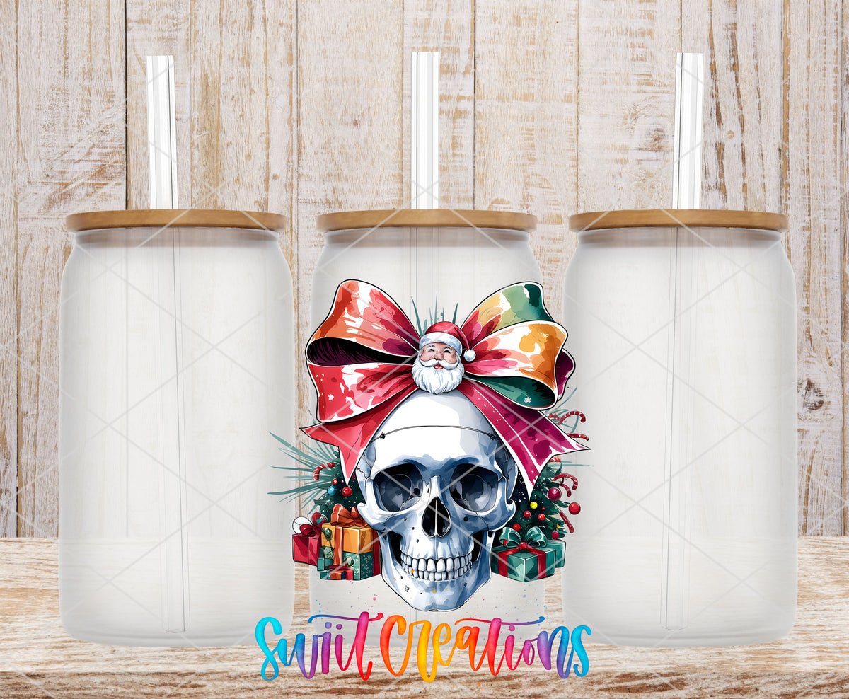 Christmas Croquette Skull UV DTF transfer on three frosted glass cans on a wood background