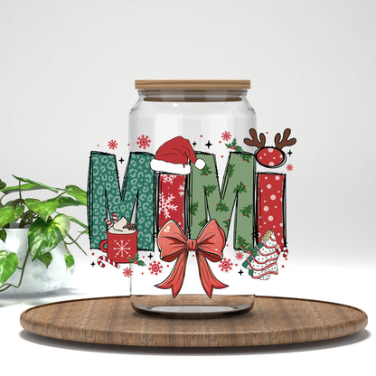 Mimi Christmas UV DTF transfer on a clear glass can on a wood tray with greenery