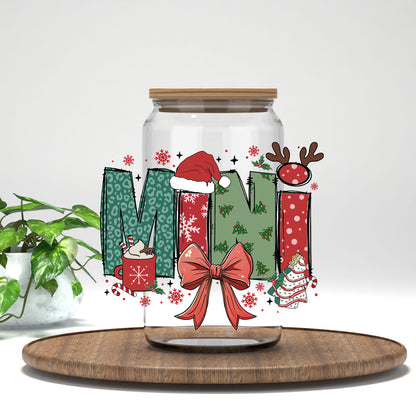 Mini Christmas UV DTF transfer on a clear glass can on a wood tray with greenery