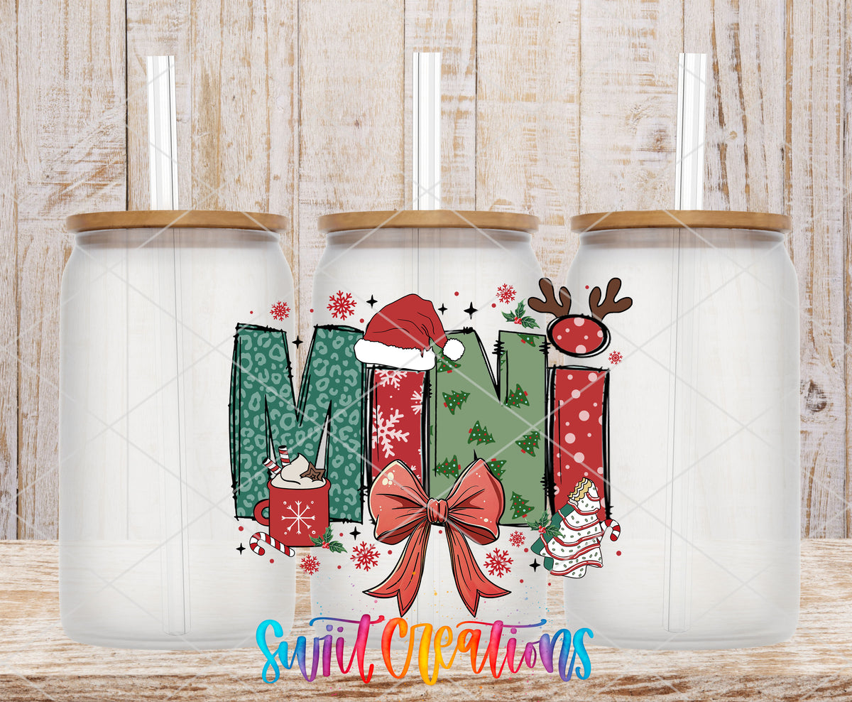 Mini Christmas UV DTF transfer on three frosted glass cans on a wood background